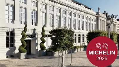 a white building with a red sign in front of it at Juliana Hotel & Spa - Brussels Centre in Brussels