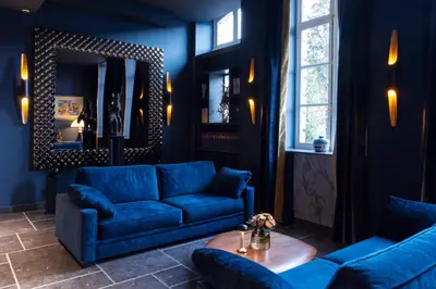 a blue living room with two blue couches and a table at Juliana Hotel & Spa - Brussels Centre in Brussels
