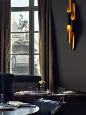 a restaurant with a view of a statue in front of a window at Juliana Hotel & Spa - Brussels Centre in Brussels