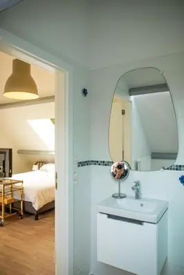 a bathroom with a sink and a mirror at DC's Home in Meise