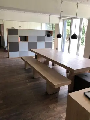 a table and benches in a room with windows at Vakantiehuis De Sneppelhoeve in Loenhout