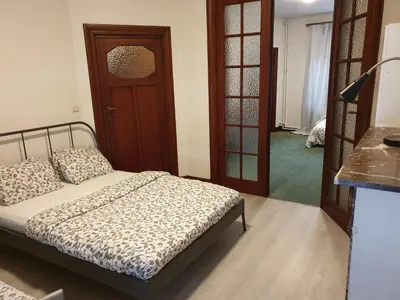 a bedroom with a bed and a room with a door at Near European District, 1-2 Bedroom Apartment. in Brussels