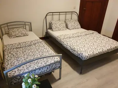 two twin beds in a room with at Near European District, 1-2 Bedroom Apartment. in Brussels