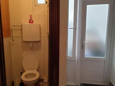 a small bathroom with a toilet and a window at Near European District, 1-2 Bedroom Apartment. in Brussels
