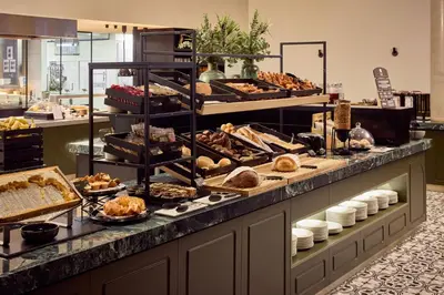 a buffet line with many different types of pastries at Van der Valk Hotel Gent in Ghent
