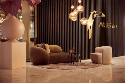 a living room with a couch and a chair at Van der Valk Hotel Gent in Ghent
