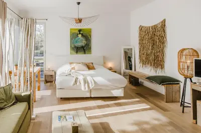 a bedroom with a bed and a couch at B&B Villa Tartine in Puurs