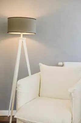a lamp next to a white couch with a pillow at B&B Villa Tartine in Puurs