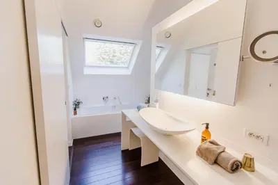 a white bathroom with a sink and a mirror at B&B Villa Tartine in Puurs