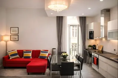 a living room with a red couch and a table at Apartments Saint Géry in Brussels
