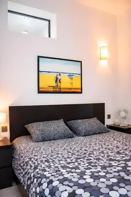 a bedroom with a bed and a tv on the wall at Apartments Saint Géry in Brussels