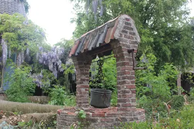 a brick oven with a bucket in a garden at Saffels Nest 33 in Lochristi