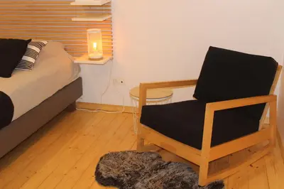 a bedroom with a bed and a chair with a candle at Saffels Nest 33 in Lochristi