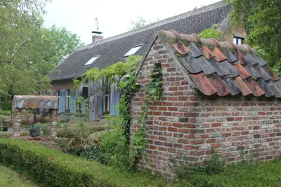an old brick house with ivy growing on it at Saffels Nest 33 in Lochristi