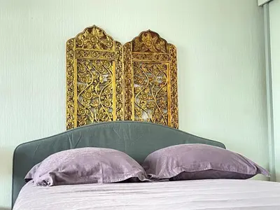 a headboard of a bed with two purple pillows at - - - - - Au Sixième Ciel - - - - - in Brussels