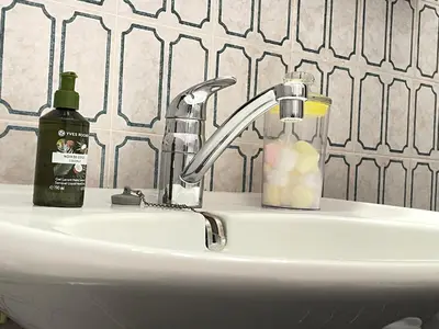 a sink with a soap dispenser and a bottle of soap at - - - - - Au Sixième Ciel - - - - - in Brussels