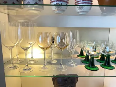 a bunch of wine glasses on a glass shelf at - - - - - Au Sixième Ciel - - - - - in Brussels