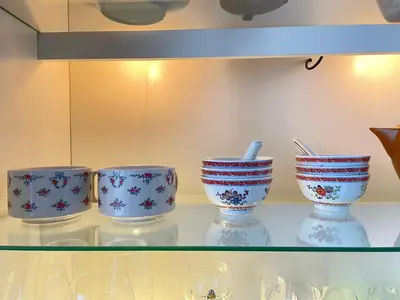a glass shelf with blue and white bowls on it at - - - - - Au Sixième Ciel - - - - - in Brussels
