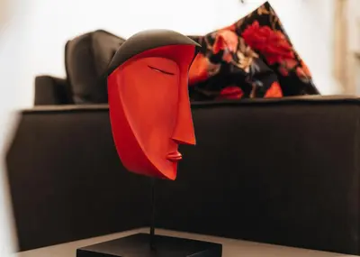 a red head sculpture on a table with a couch at R213 Residences Botanique in Brussels