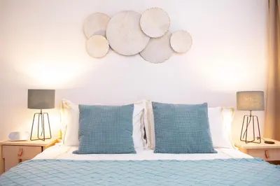 a bedroom with a bed with blue pillows and two lamps at R213 Residences Botanique in Brussels