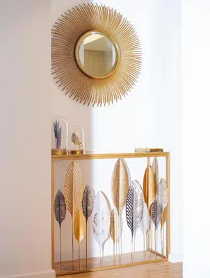 a gold mirror hanging above a shelf with plates at R213 Residences Botanique in Brussels