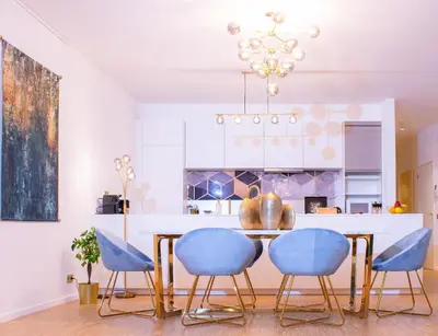 a dining room with a table and blue chairs at R213 Residences Botanique in Brussels