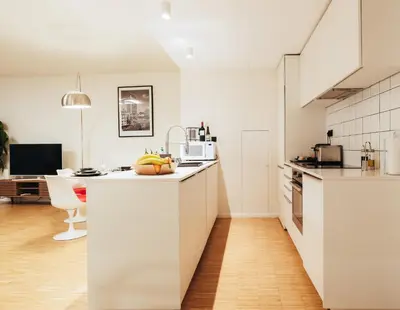 a white kitchen with a sink and a counter top at R213 Residences Botanique in Brussels