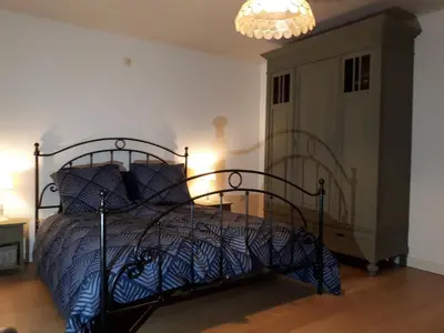 a bedroom with a bed and a chandelier at Vertentenhuis in Hamme