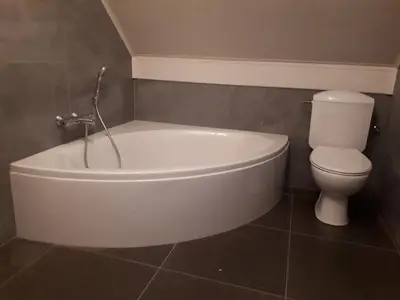 a bathroom with a white tub and a toilet at Vertentenhuis in Hamme