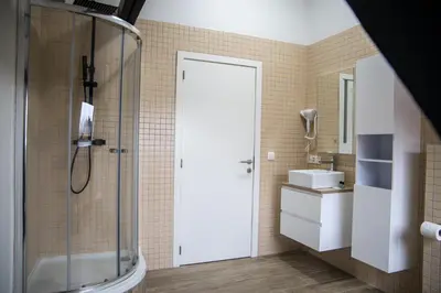 a bathroom with a shower and a sink at Hotel Guzy Lier Centre in Lier