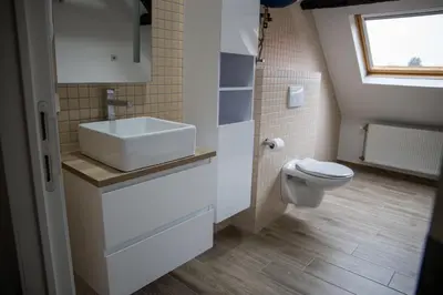 a bathroom with a sink and a toilet at Hotel Guzy Lier Centre in Lier