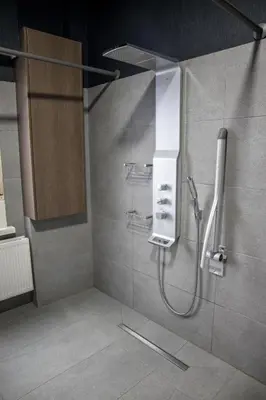 a bathroom with a shower with a sink and a shower at Hotel Guzy Lier Centre in Lier