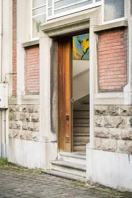 a door to a building with a poster on it at B&B Tempelhof in Ghent