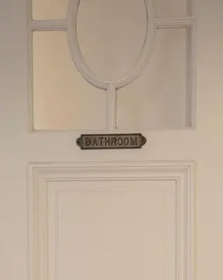 a door with a mirror and a sign on it at ADA in Antwerp