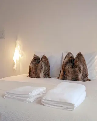 a bed with white towels on top of it at ADA in Antwerp