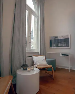 a living room with a chair and a window at ADA in Antwerp