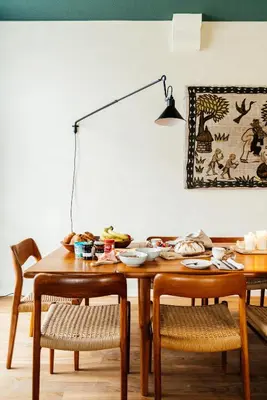 a dining room table with chairs and a lamp at Chambre d'Amis by Alix in Ghent