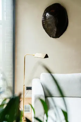 a living room with a couch and a clock on the wall at Chambre d'Amis by Alix in Ghent