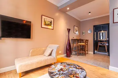 a living room with a couch and a tv at Luxury Suites Boutique by Rikas Hotels in Antwerp
