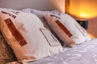 a group of pillows sitting on top of a bed at Luxury Suites Boutique by Rikas Hotels in Antwerp
