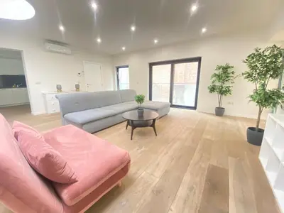 a living room with a couch and a table at The Central Square Residence in Antwerp