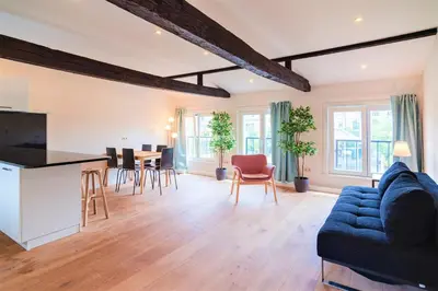 a living room with a blue couch and a table at The Central Square Residence in Antwerp