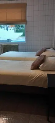 two beds sitting next to each other in a room at Wenceslas cobergher appartement I in Boutersem