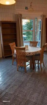 a dining room with a wooden table and chairs at Wenceslas cobergher appartement I in Boutersem