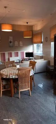 a living room with a table and chairs and a couch at Wenceslas cobergher appartement I in Boutersem