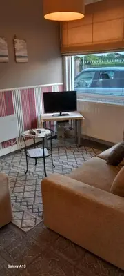 a living room with a couch and a table and a piano at Wenceslas cobergher appartement I in Boutersem