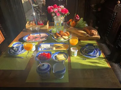 a table with breakfast foods and oranges on it at B&B Carisma in Lochristi