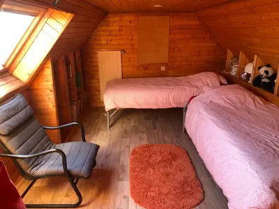 a room with two beds and a couch in a cabin at B&B Carisma in Lochristi