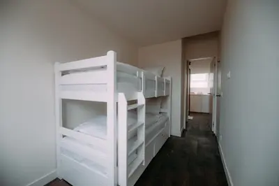 a bunk bed room with white bunk beds at Sud d'Anvers in Antwerp