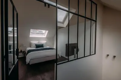 a bedroom with a bed and a television in it at Sud d'Anvers in Antwerp
